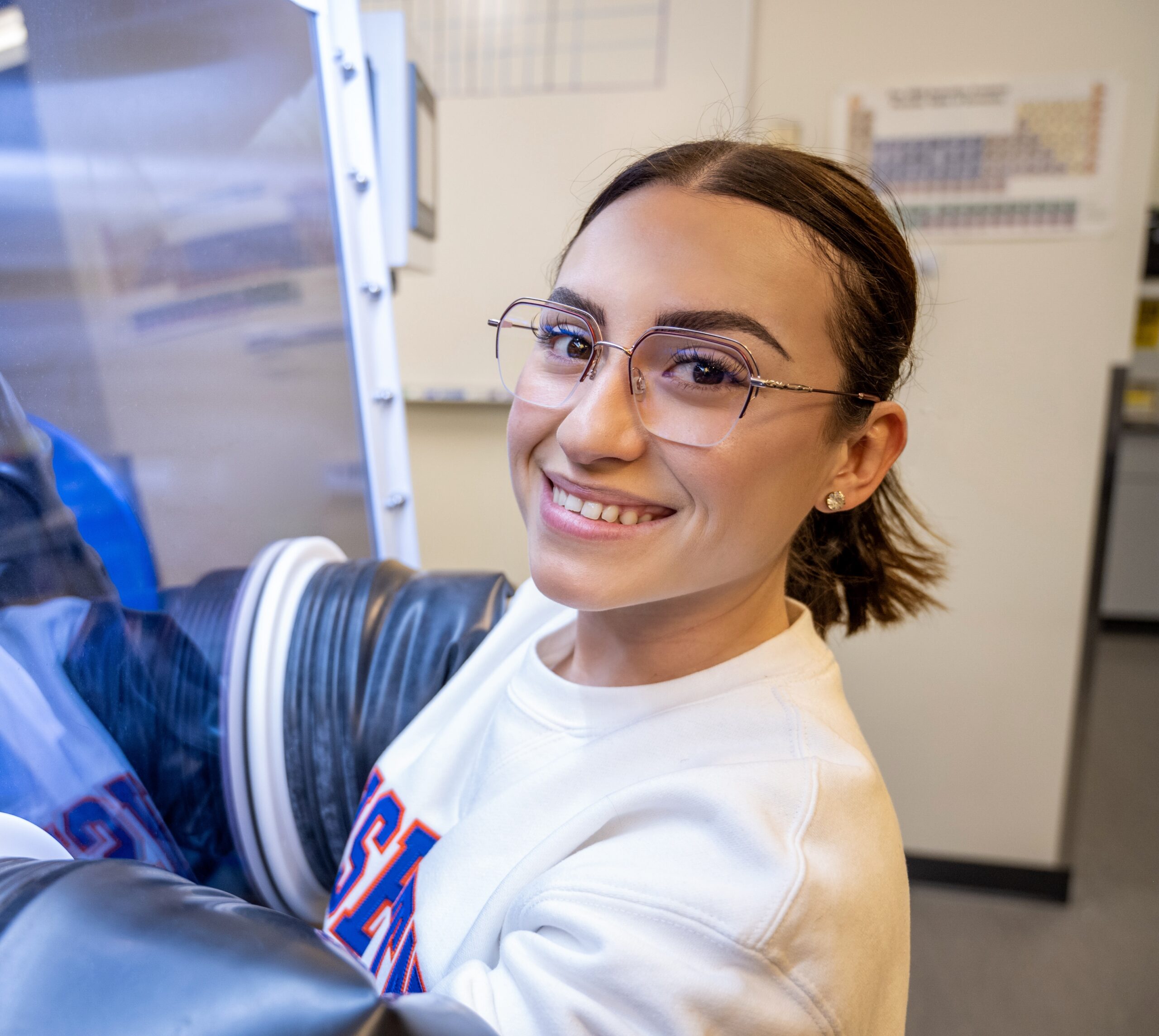 A student works with equipment in a laboratory.